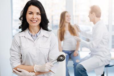 female doctor and woman with male doctor